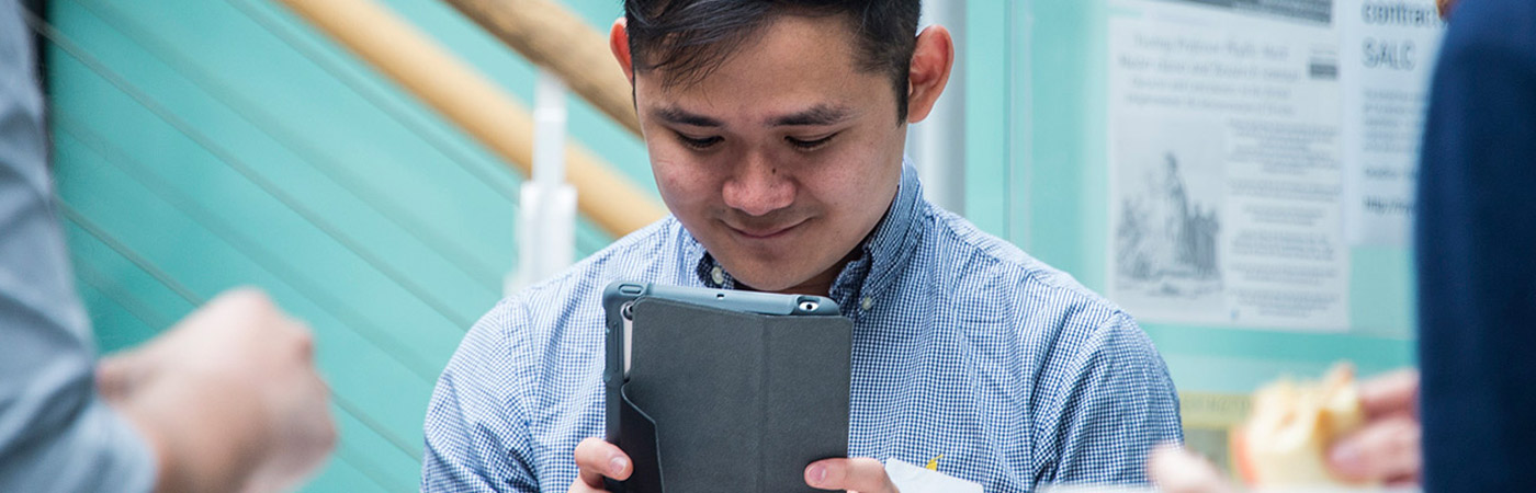 student on ipad at event